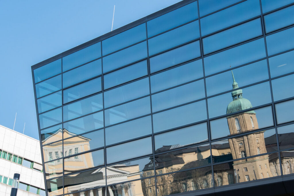 The windows of the Congress Center in Darmstadt reflecting the building of the State Museum of Hessen.